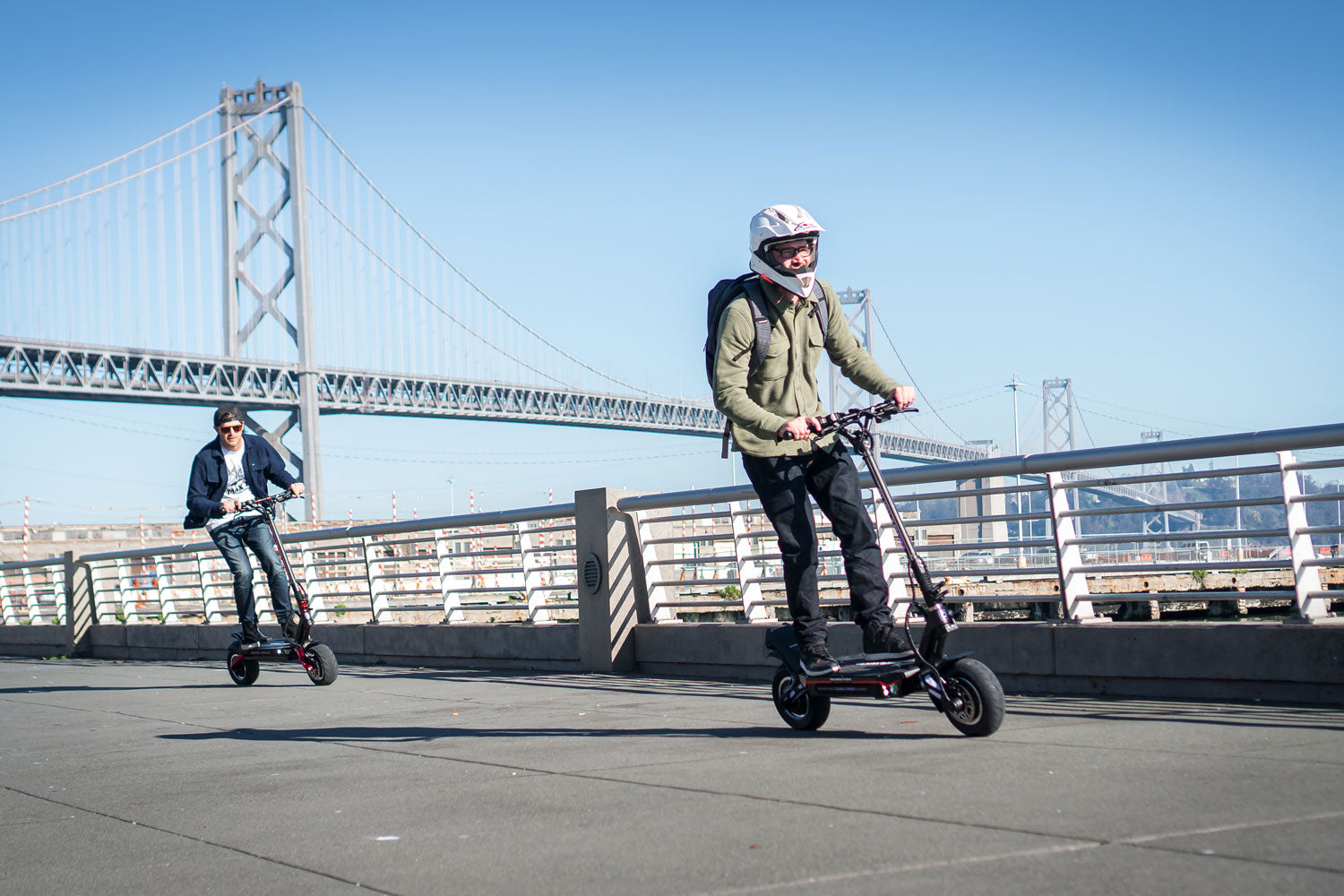 Riders on Dualtron electric scooters on an open California road