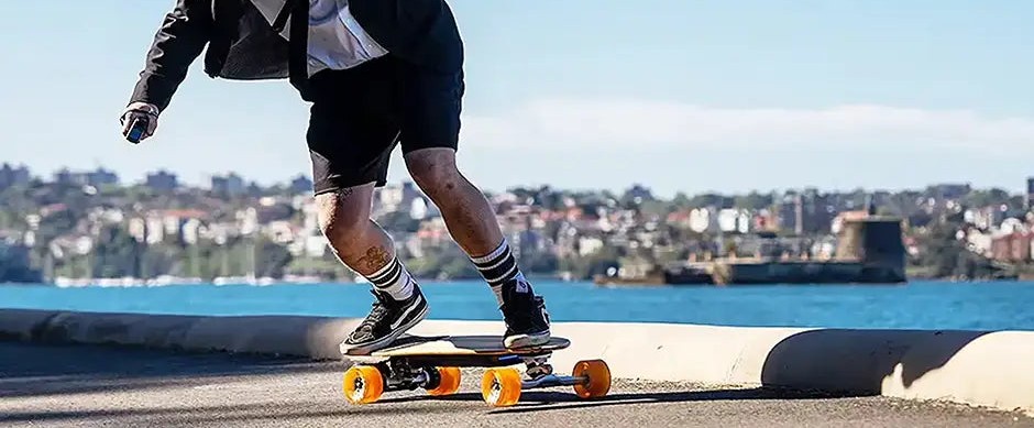 Rider on an Evolve electric skateboard along the coast